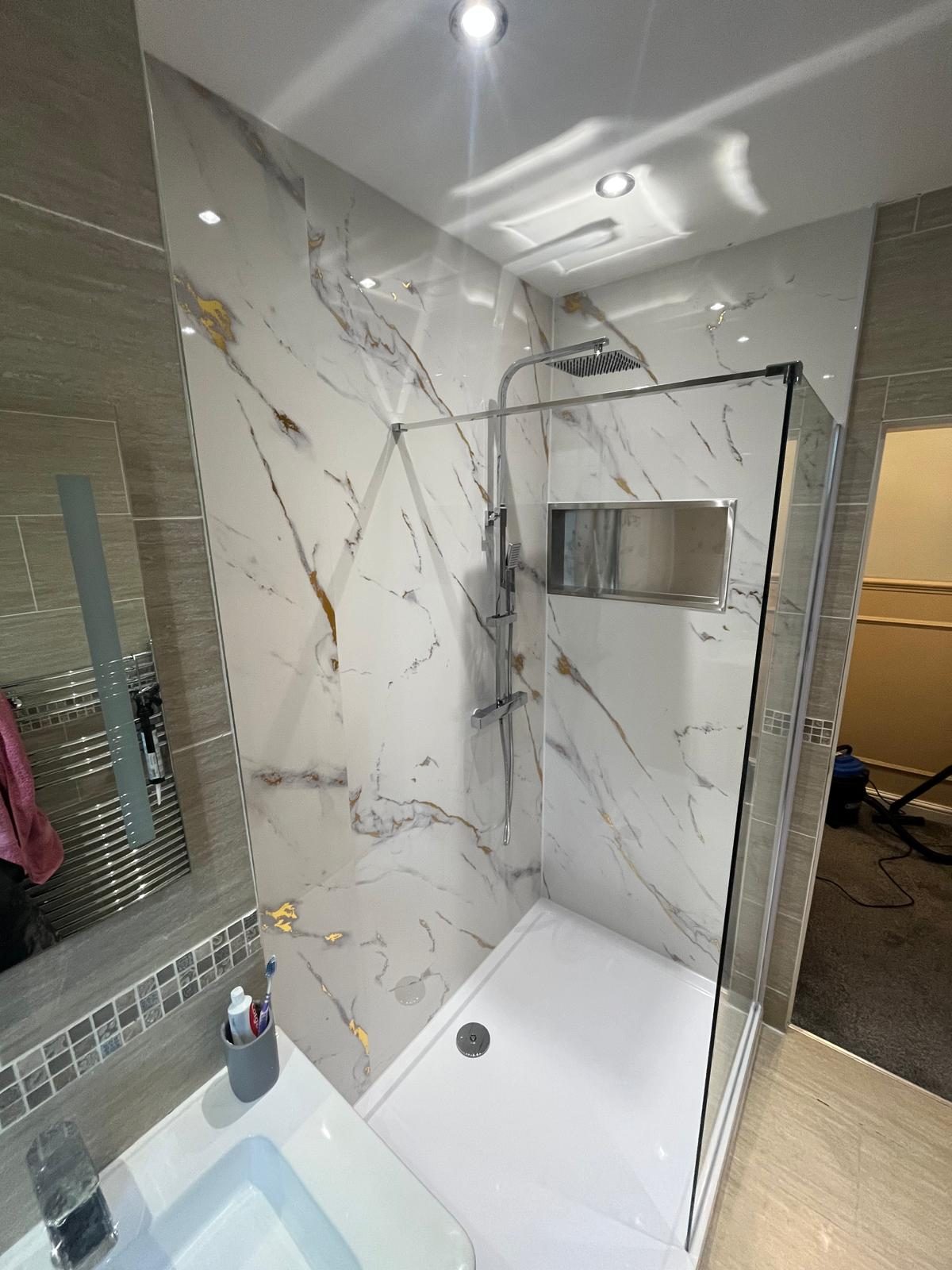 Walk-in shower with rectangular tray, glass screen and chrome rainfall shower installed