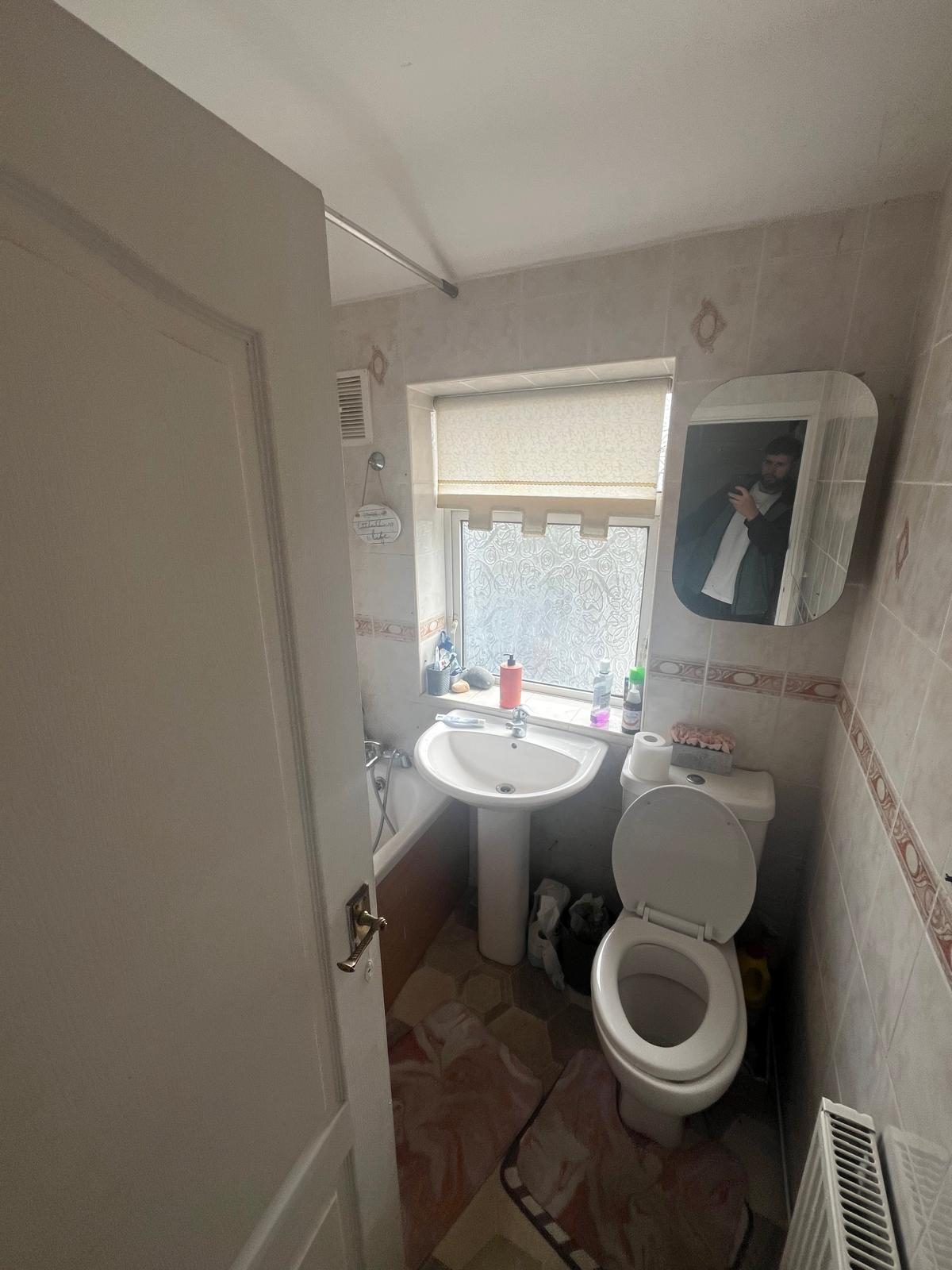 Dated bathroom with old bath, pedestal basin and tiled walls before renovation in Lytham St Anne's