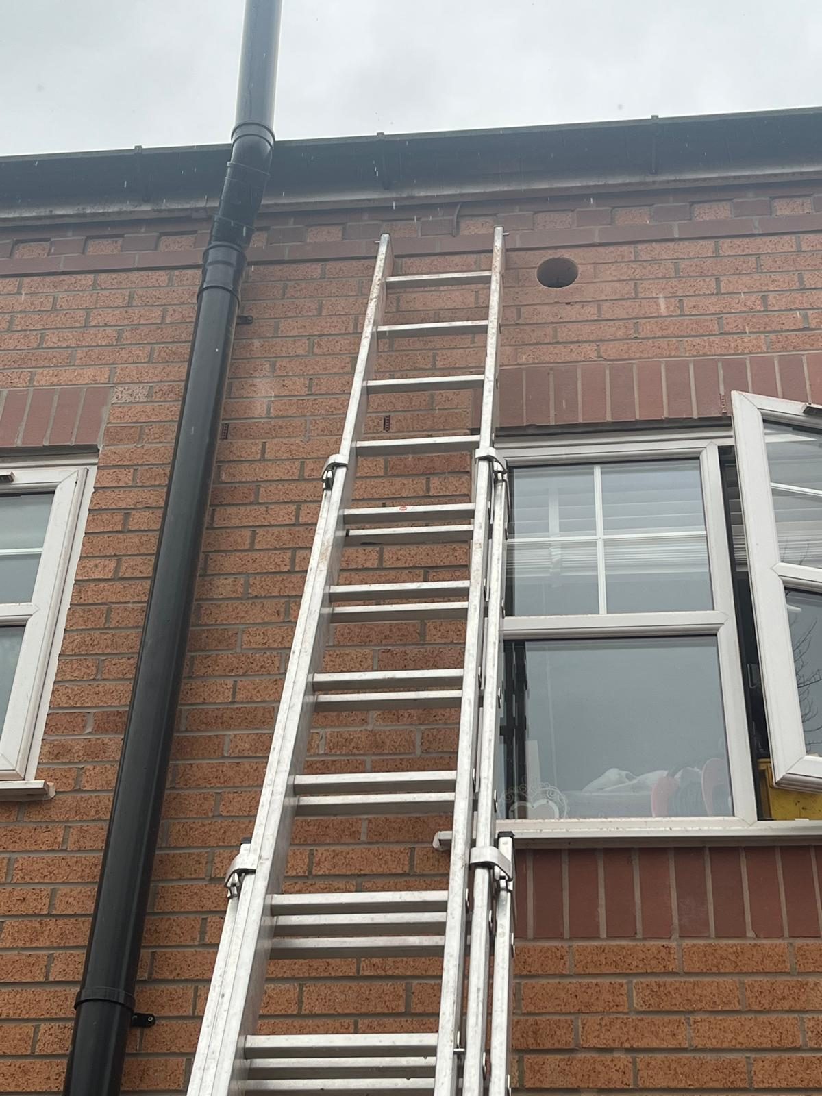 Ladder set up against a house for external plumbing and soil pipe work