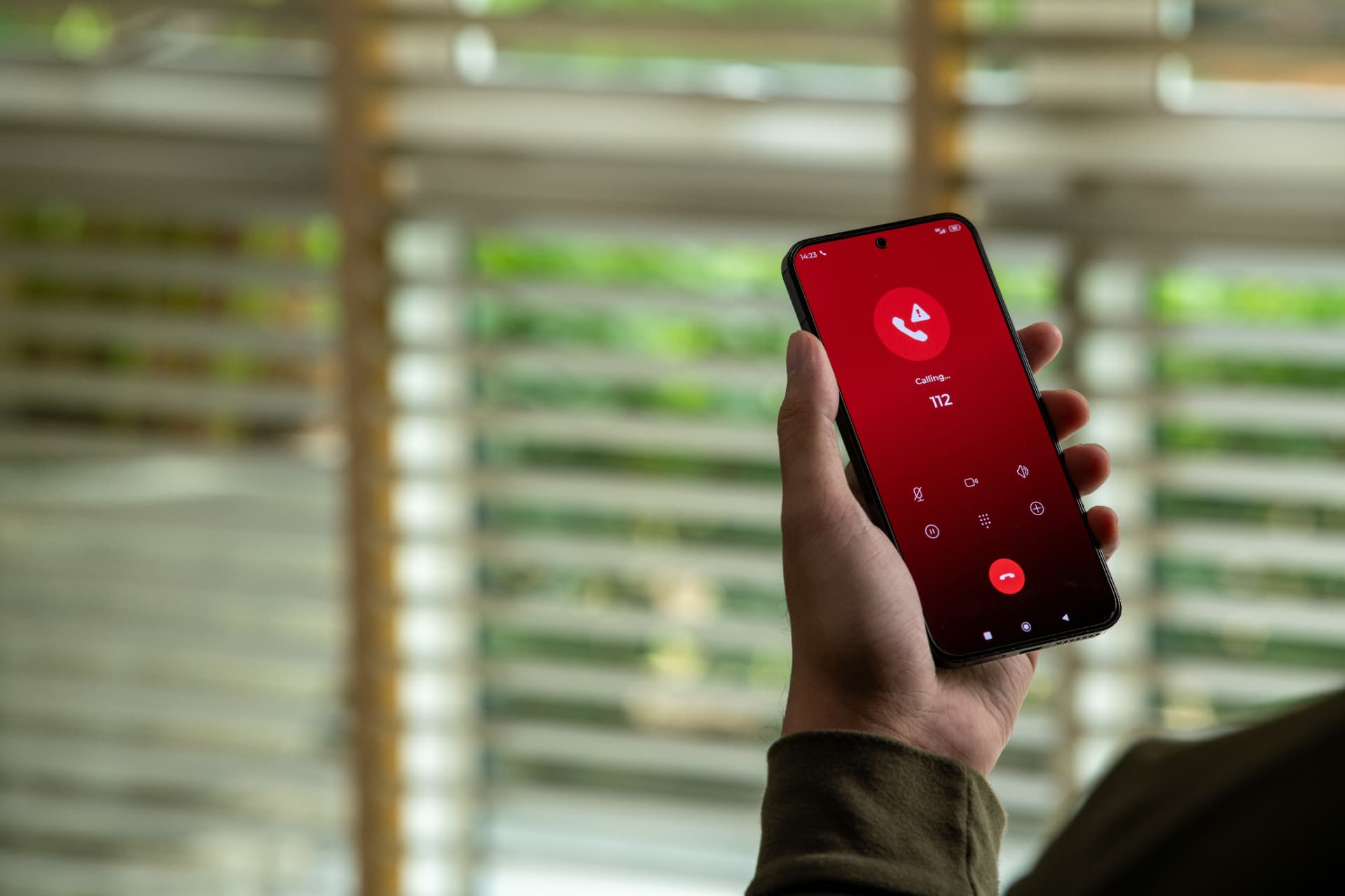 Homeowner making an emergency plumbing call out on a mobile phone
